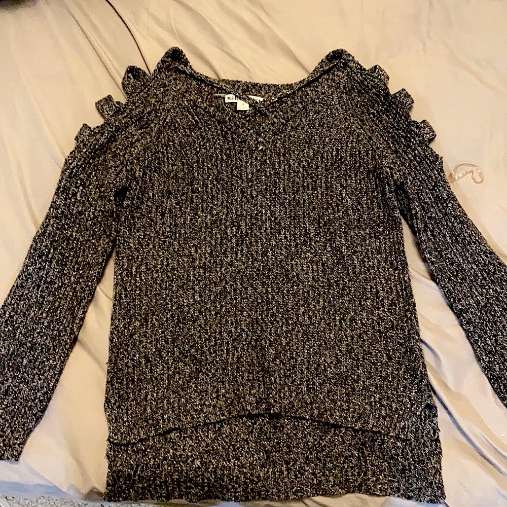 It is a grey sweater. And it has cuts in the arms. It is not low cut.